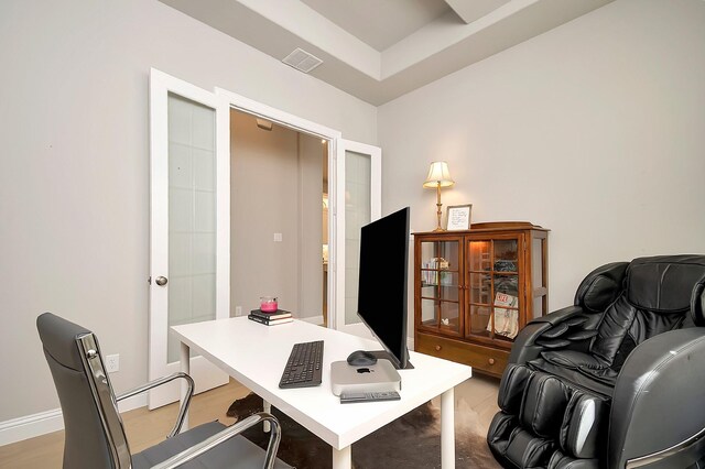 office featuring a raised ceiling and french doors