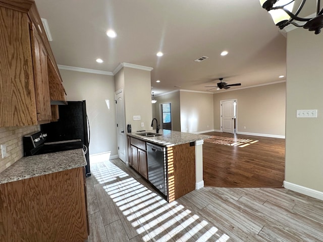 kitchen with stainless steel dishwasher, ceiling fan, sink, and light hardwood / wood-style flooring