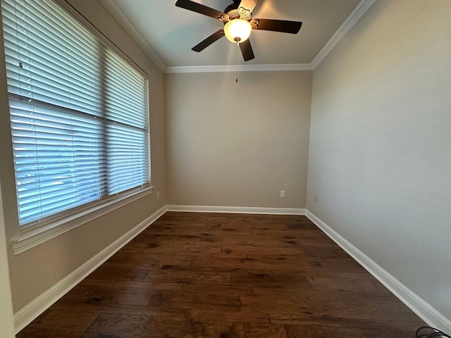 spare room featuring plenty of natural light, ceiling fan, dark hardwood / wood-style flooring, and ornamental molding