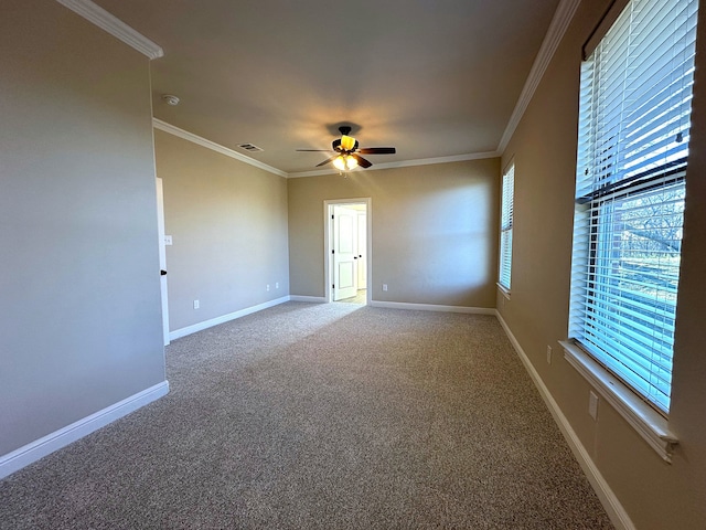 carpeted spare room featuring ceiling fan and crown molding