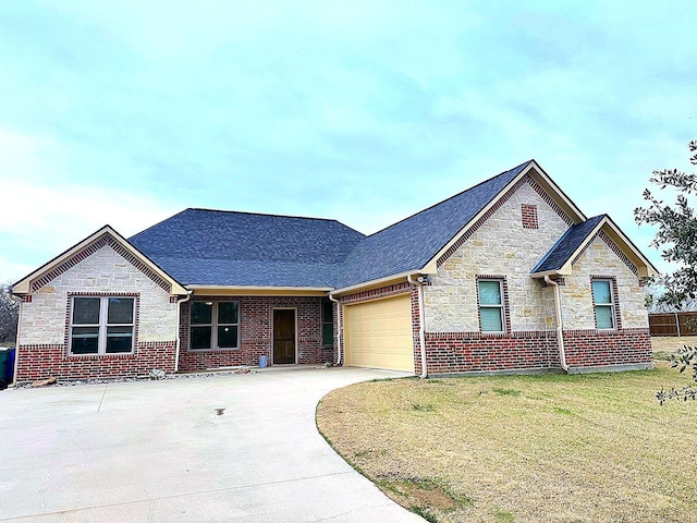 view of front of home with a front lawn and a garage