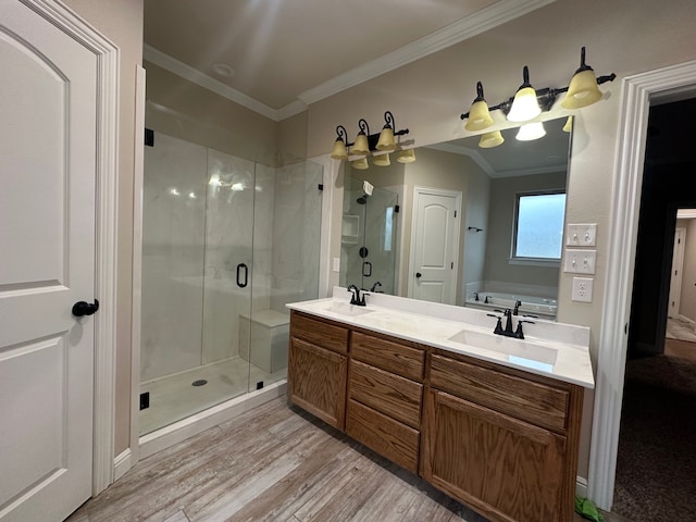 bathroom featuring ornamental molding, vanity, independent shower and bath, and wood-type flooring