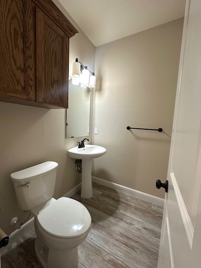 bathroom featuring hardwood / wood-style floors and toilet