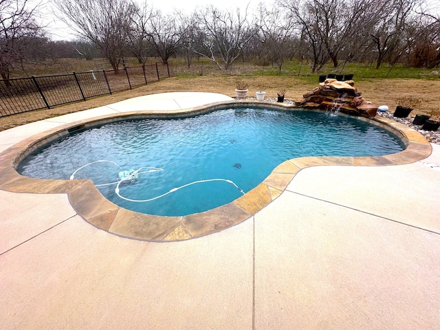 view of pool featuring pool water feature and a patio