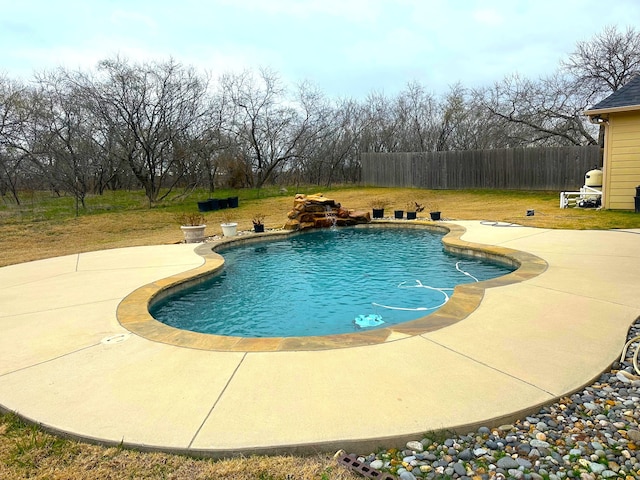 view of pool with a lawn, a patio area, and pool water feature