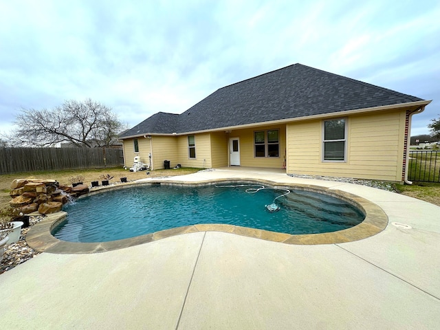 view of pool with pool water feature and a patio