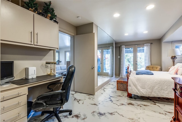 bedroom featuring french doors and built in desk