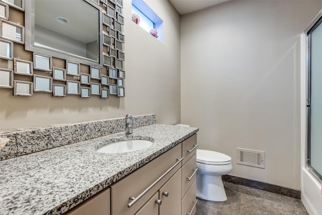 full bathroom featuring enclosed tub / shower combo, vanity, and toilet