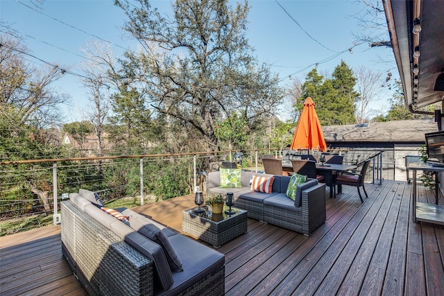 wooden terrace with an outdoor living space