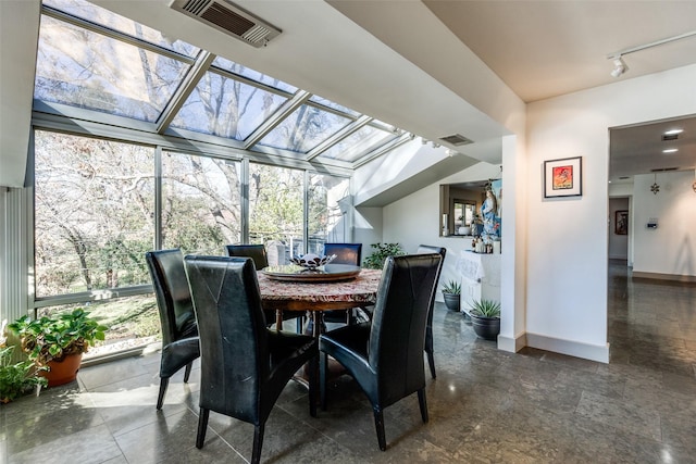 sunroom featuring visible vents and rail lighting