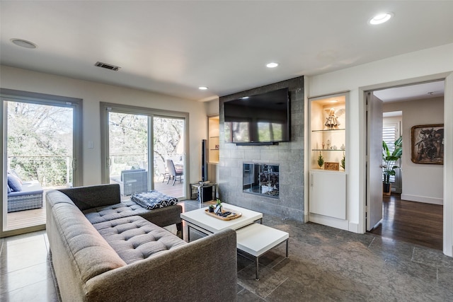 living room with a tiled fireplace