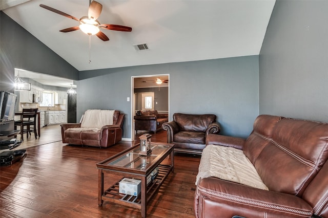 living room with dark wood-type flooring and vaulted ceiling