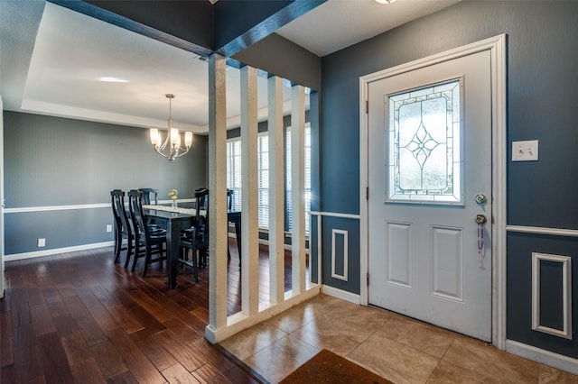 foyer with a chandelier and hardwood / wood-style floors