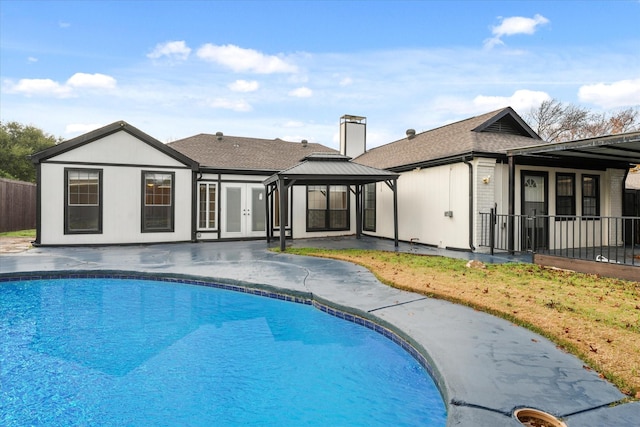 view of pool featuring fence, a gazebo, french doors, a fenced in pool, and a patio area