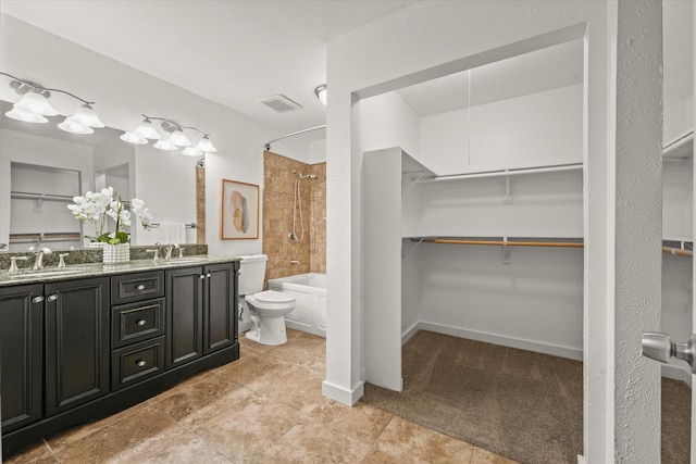 full bathroom with toilet, vanity, and tiled shower / bath