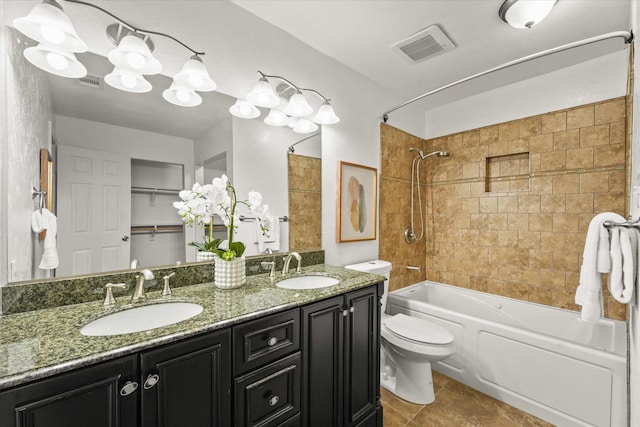 full bathroom featuring tile patterned floors, vanity, toilet, and tiled shower / bath