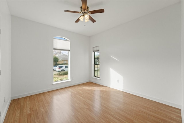 spare room with light wood-type flooring and ceiling fan