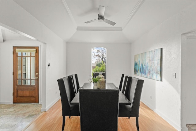 dining room with a raised ceiling, ceiling fan, crown molding, and light wood-type flooring