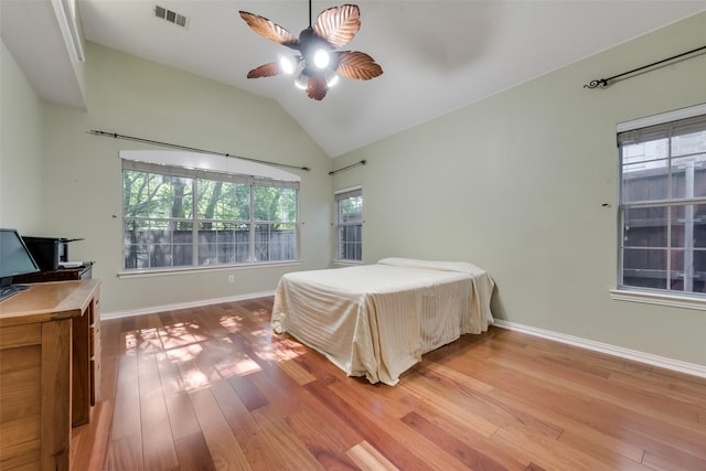 bedroom with hardwood / wood-style flooring, lofted ceiling, and ceiling fan