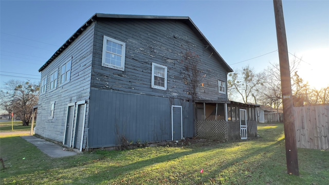 view of side of home with a lawn