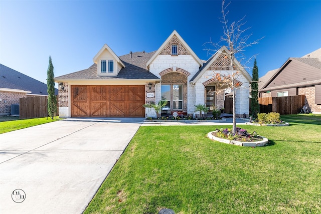 view of front of home with central AC, a front lawn, and a garage