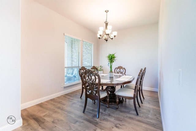 dining area with a chandelier and dark hardwood / wood-style flooring