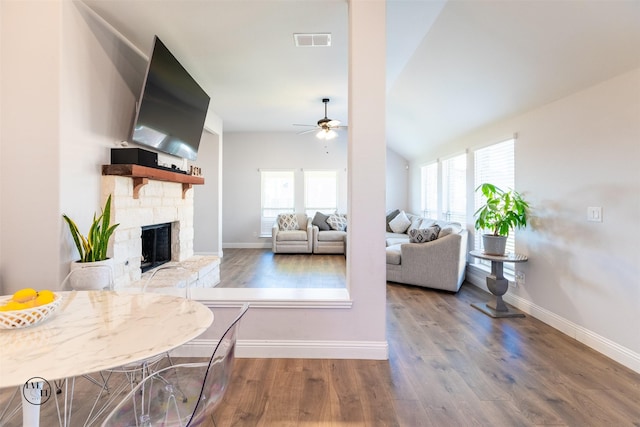 living room featuring a fireplace, ceiling fan, plenty of natural light, and hardwood / wood-style flooring