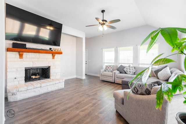 living room featuring ceiling fan, a stone fireplace, lofted ceiling, and dark wood-type flooring