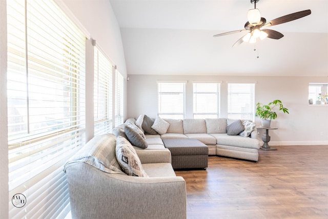 living room with hardwood / wood-style flooring, ceiling fan, and lofted ceiling