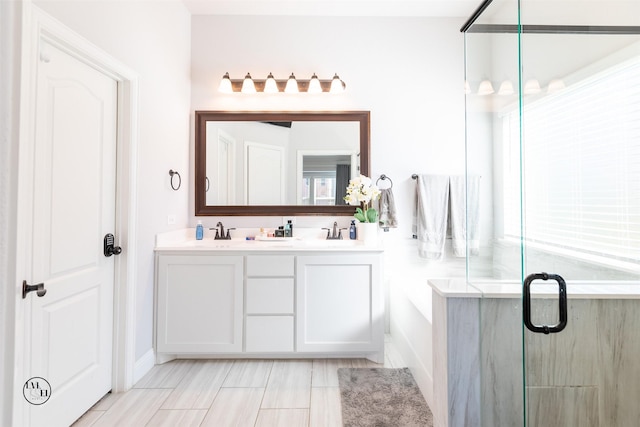 bathroom with vanity and a shower with door