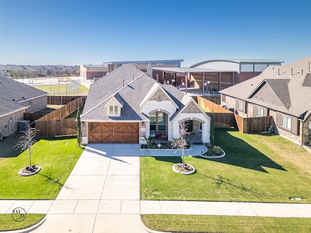 view of front of house featuring a garage and a front lawn