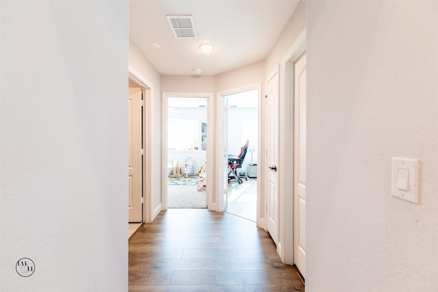 hallway with wood-type flooring