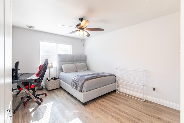 bedroom with ceiling fan and light hardwood / wood-style floors