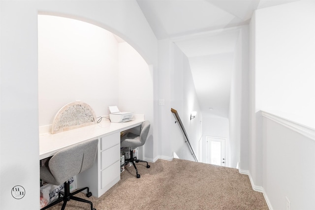 carpeted home office featuring lofted ceiling