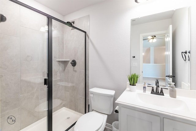 bathroom featuring vanity, toilet, and a shower with door