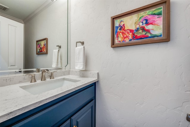 bathroom with vanity and ornamental molding