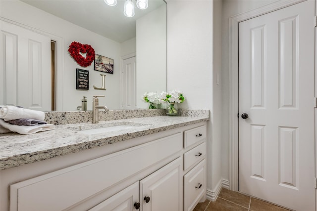 bathroom featuring tile patterned flooring and vanity