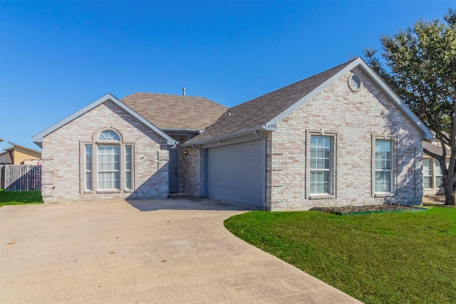 view of front of home featuring a front lawn and a garage