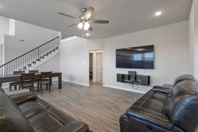 living room with ceiling fan and hardwood / wood-style flooring