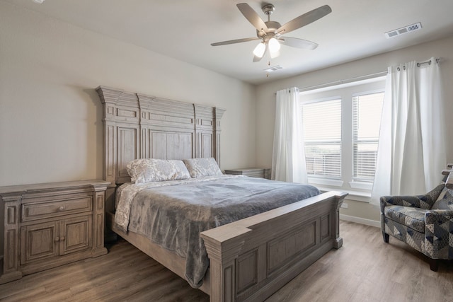 bedroom with hardwood / wood-style flooring and ceiling fan