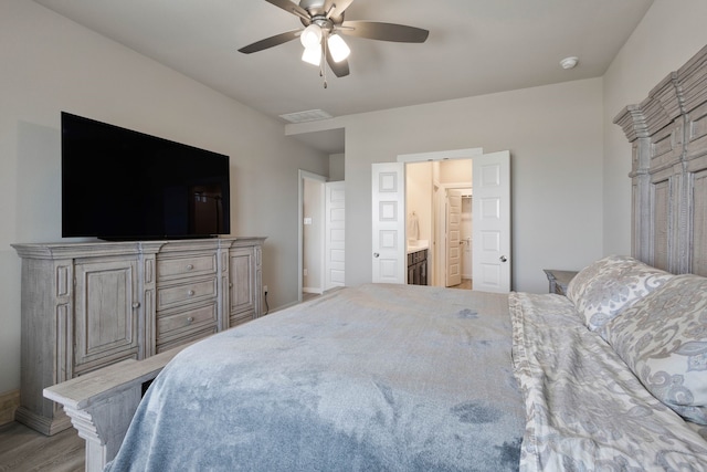 bedroom with ensuite bathroom and ceiling fan