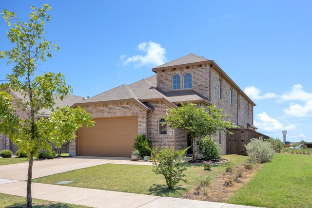 view of front of home featuring a front lawn and a garage