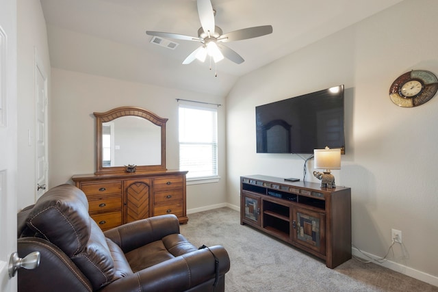 carpeted living room with ceiling fan and lofted ceiling