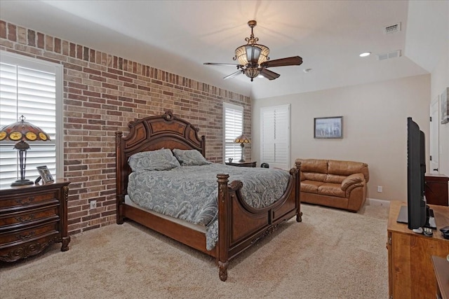 carpeted bedroom featuring ceiling fan and brick wall