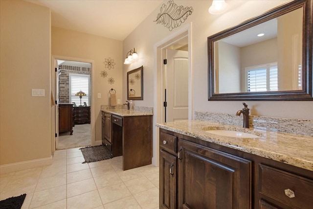 bathroom with tile patterned flooring, vanity, and a wealth of natural light