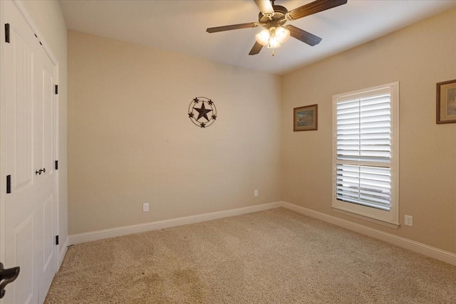 empty room featuring carpet floors and ceiling fan