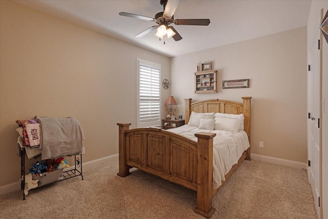 bedroom featuring ceiling fan and light carpet