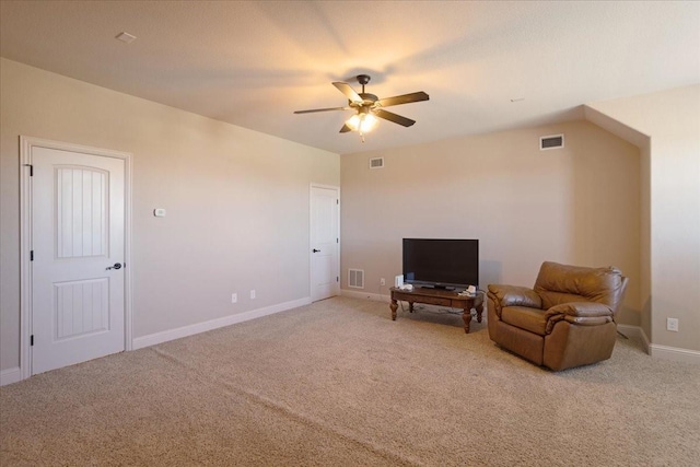 living area with light carpet and ceiling fan