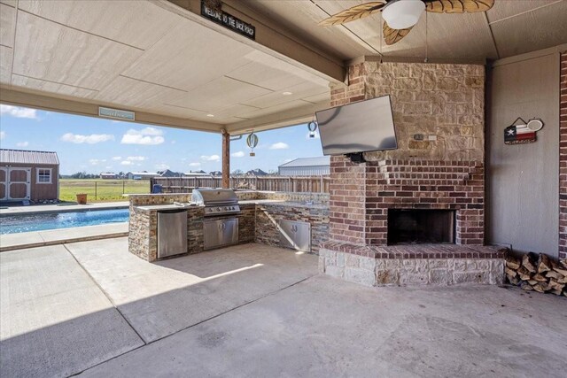 view of patio / terrace with exterior kitchen, area for grilling, an outdoor brick fireplace, ceiling fan, and a fenced in pool