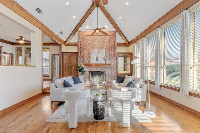 living room with light hardwood / wood-style flooring, vaulted ceiling, and ornamental molding